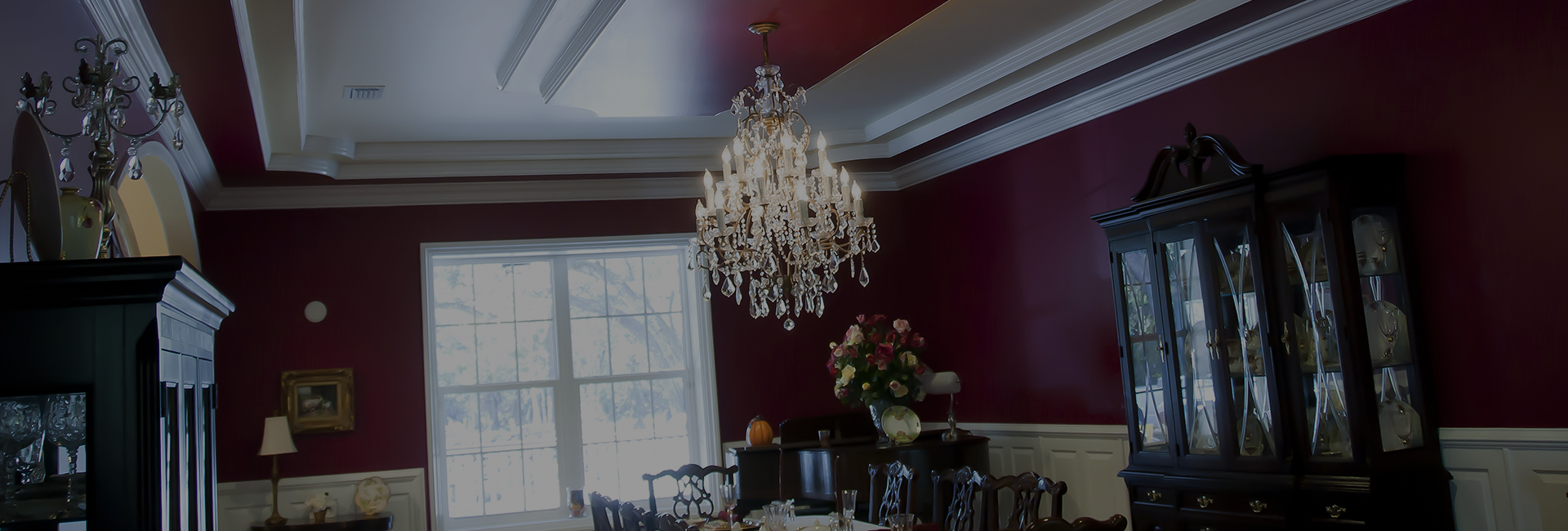 red dining room with crystal chandelier